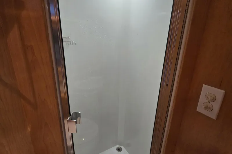  Yacht Photos Pics Shower enclosure in 1997 Navigator 5000 Classic, featuring frosted glass door and wooden paneling.