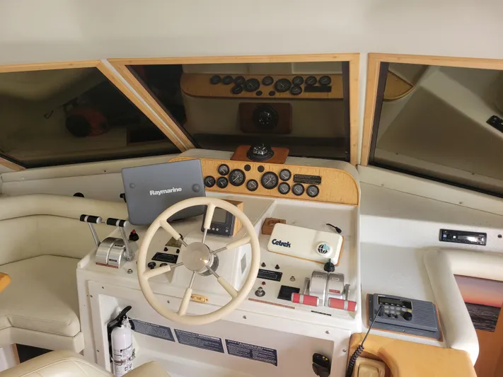  Yacht Photos Pics 1997 Navigator 5000 Classic yacht helm with steering wheel and navigation equipment.