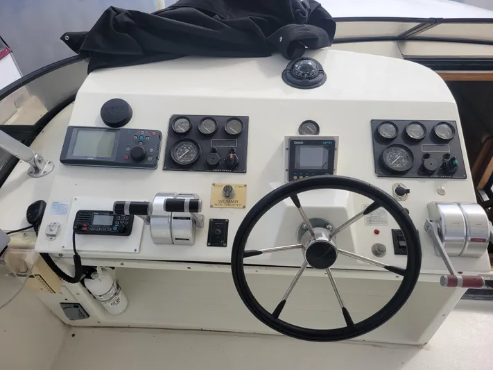  Yacht Photos Pics Control panel of a 1997 Navigator 5000 Classic boat with steering wheel and gauges.