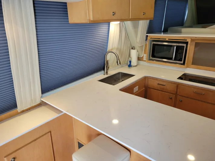  Yacht Photos Pics Modern kitchen in 1997 Navigator 5000 Classic yacht with sink, microwave, and stovetop.