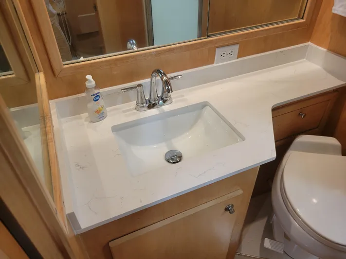  Yacht Photos Pics Bathroom sink area in 1997 Navigator 5000 Classic with marble countertop and chrome faucet.