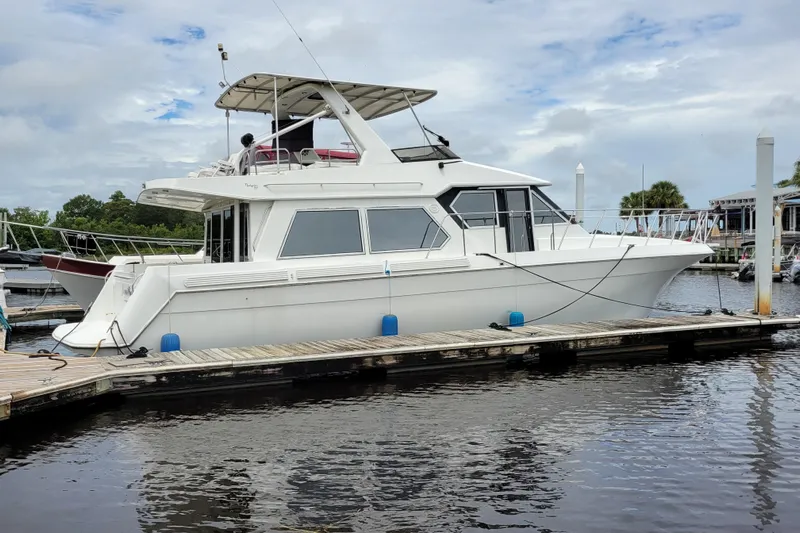  Yacht Photos Pics 1997 Navigator 5000 Classic yacht docked at marina, featuring sleek white design and spacious deck.