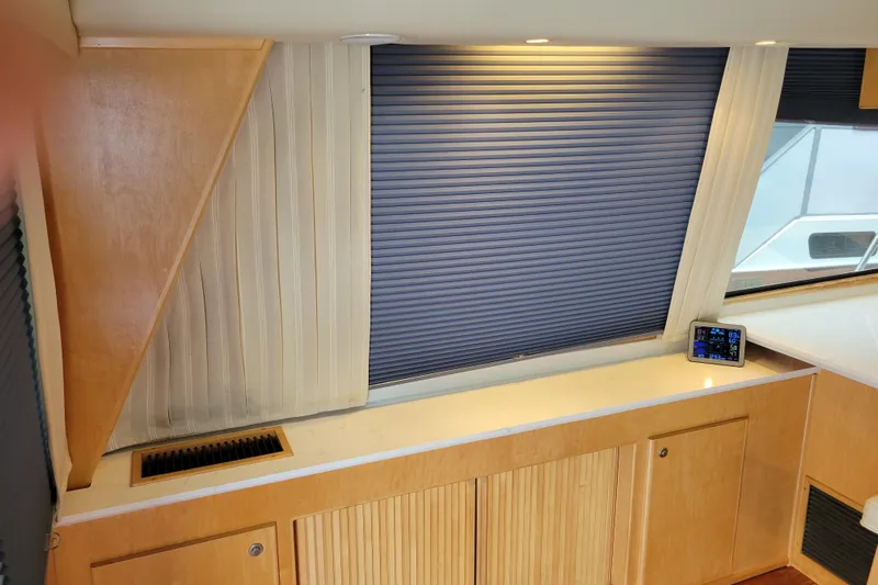  Yacht Photos Pics Interior of 1997 Navigator 5000 Classic yacht with wooden cabinetry and window blinds.