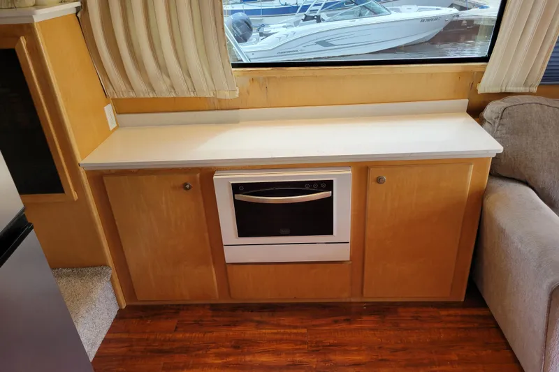  Yacht Photos Pics 1997 Navigator 5000 Classic interior with wooden cabinetry and a built-in oven.