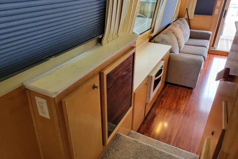  Yacht Photos Pics Interior of a 1997 Navigator 5000 Classic with wood flooring and cozy seating.