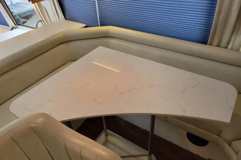  Yacht Photos Pics Interior of 1997 Navigator 5000 Classic with marble-style dining table and leather seating.