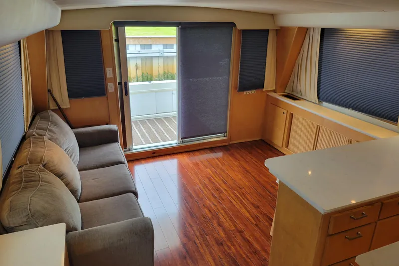  Yacht Photos Pics Interior of 1997 Navigator 5000 Classic yacht with cozy seating and wooden flooring.