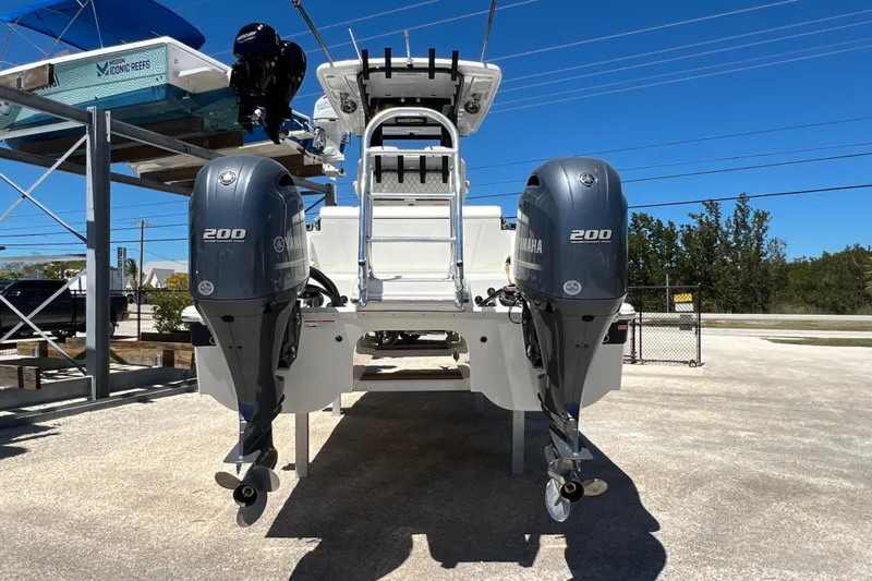  Yacht Photos Pics 2024 World Cat 260 CC-X boat with dual Yamaha 200 engines, parked outdoors.