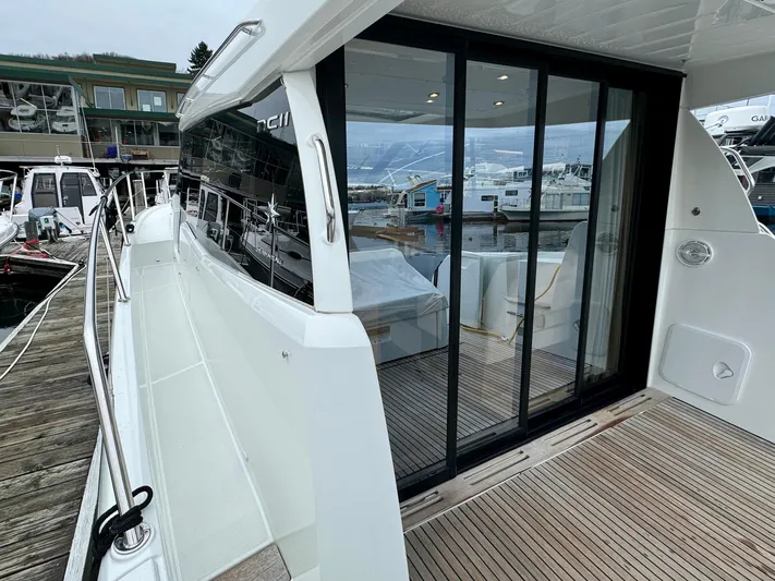 September II Yacht Photos Pics 2018 Jeanneau NC 11 yacht docked, featuring sliding glass doors and spacious deck.