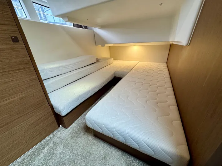 September II Yacht Photos Pics 2018 Jeanneau NC 11 cabin with twin beds and modern lighting.