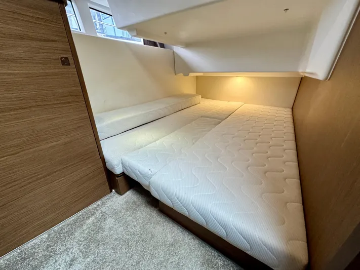 September II Yacht Photos Pics 2018 Jeanneau NC 11 cabin with twin beds and modern lighting.