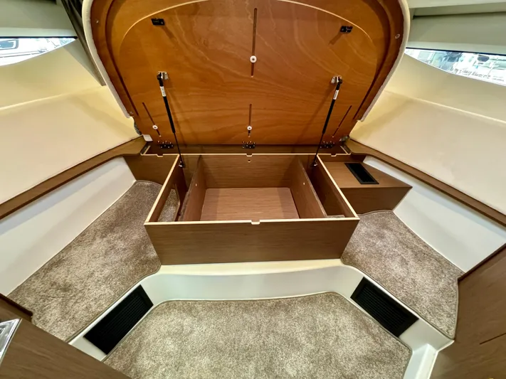 September II Yacht Photos Pics 2018 Jeanneau NC 11 cabin interior with open storage compartments.