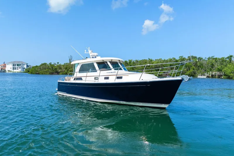 Five O'clock Yacht Photos Pics 2013 Sabre 38 Salon Express yacht cruising on clear blue water.