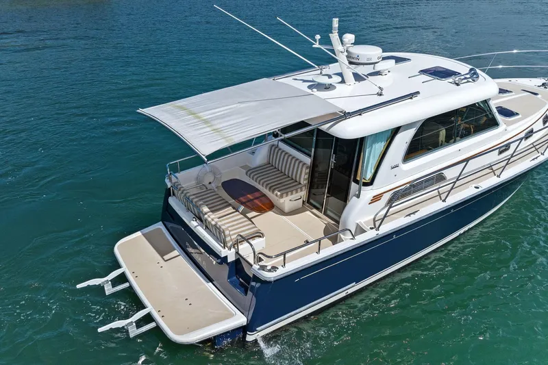 Five O'clock Yacht Photos Pics 2013 Sabre 38 Salon Express yacht on clear blue water, rear view.