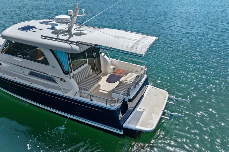 Five O'clock Yacht Photos Pics 2013 Sabre 38 Salon Express yacht on calm blue water, featuring a spacious deck.