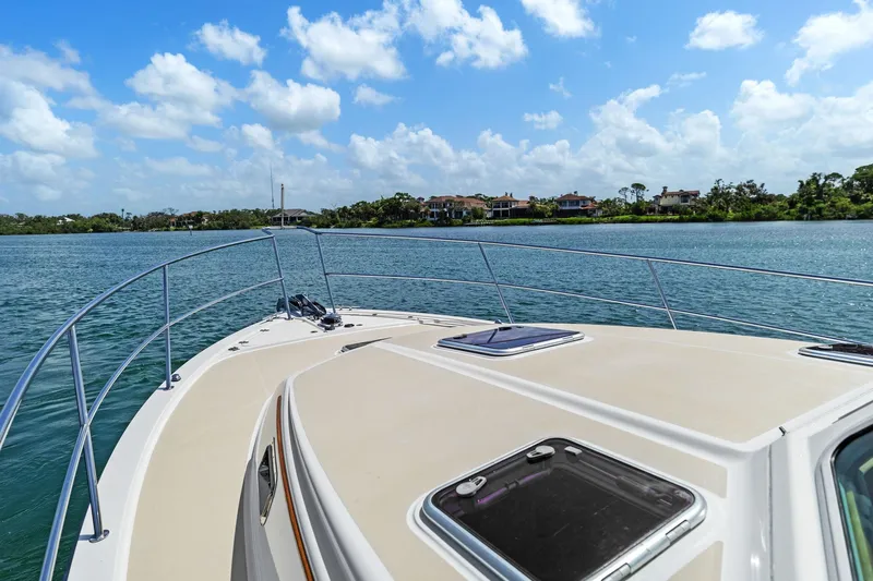 Five O'clock Yacht Photos Pics 2013 Sabre 38 Salon Express yacht cruising on a sunny day with scenic waterfront views.