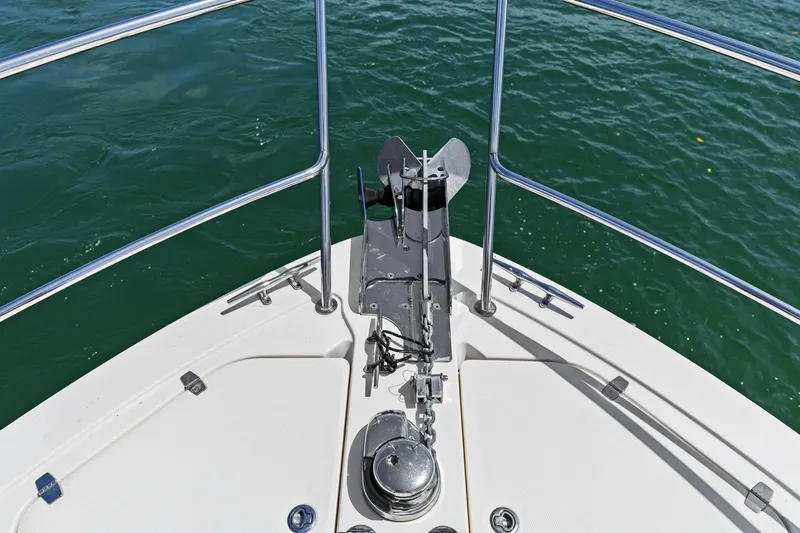 Five O'clock Yacht Photos Pics Bow of 2013 Sabre 38 Salon Express with anchor and railing over water.