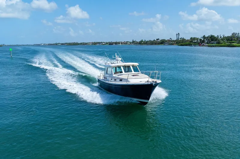 Five O'clock Yacht Photos Pics 2013 Sabre 38 Salon Express cruising on a sunny day, leaving a wake behind.