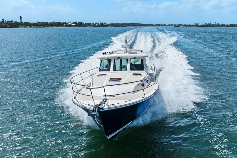 Five O'clock Yacht Photos Pics 2013 Sabre 38 Salon Express cruising on open water, creating a dynamic wake.