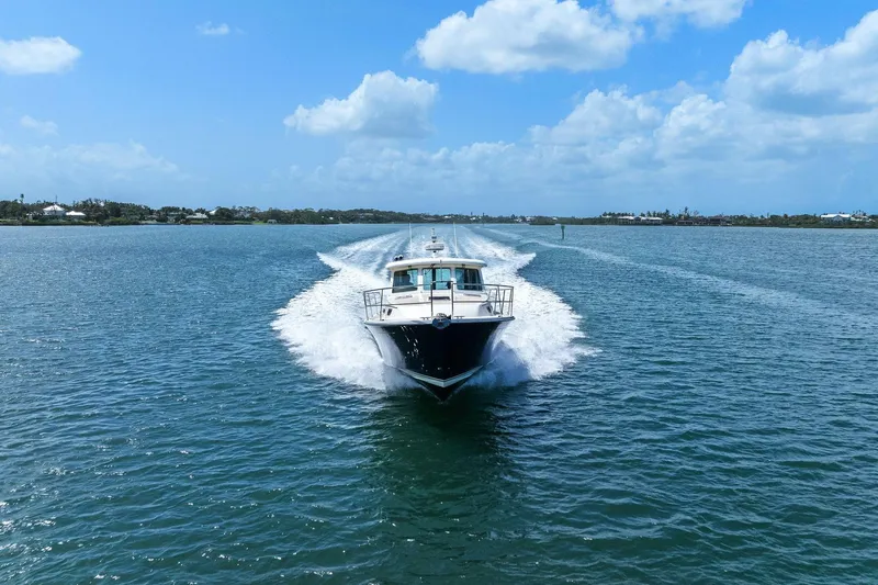 Five O'clock Yacht Photos Pics 2013 Sabre 38 Salon Express cruising on open water under a clear blue sky.