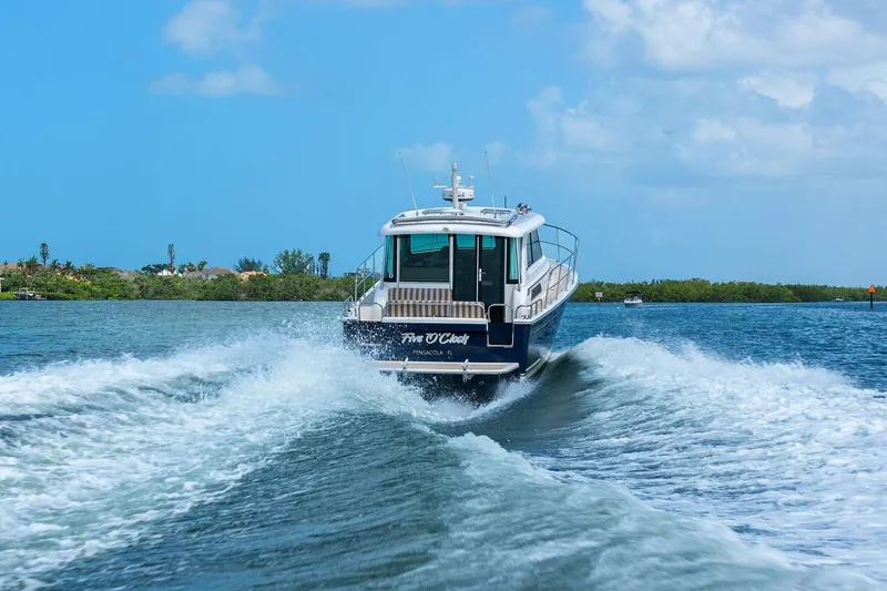 Five O'clock Yacht Photos Pics 2013 Sabre 38 Salon Express cruising on a sunny day, leaving a wake behind.
