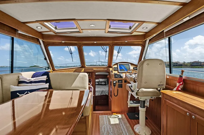 Five O'clock Yacht Photos Pics Interior of 2013 Sabre 38 Salon Express yacht with helm, seating, and panoramic windows.