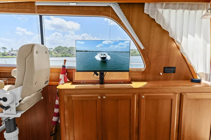 Five O'clock Yacht Photos Pics Interior of 2013 Sabre 38 Salon Express with TV and helm chair.