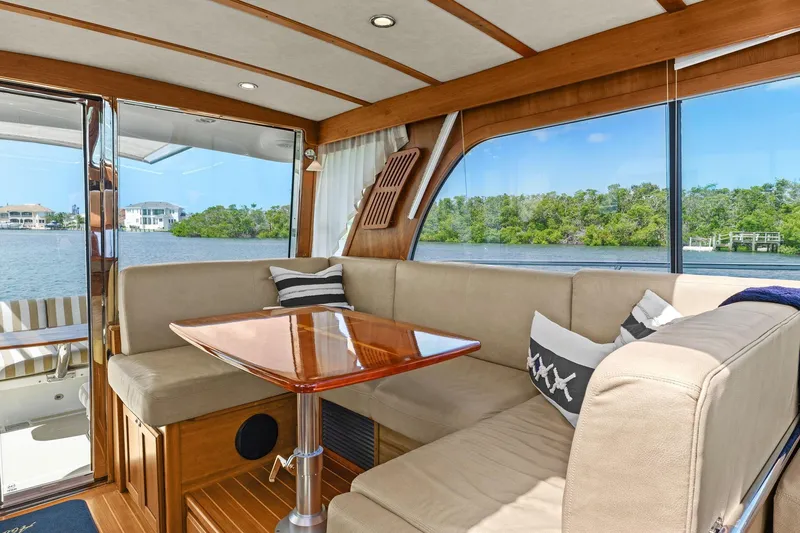 Five O'clock Yacht Photos Pics Interior of 2013 Sabre 38 Salon Express yacht with plush seating and scenic water view.