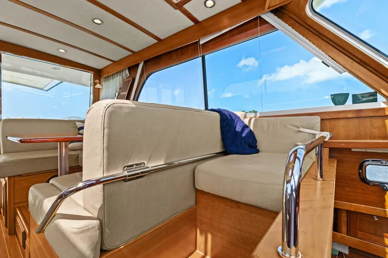 Five O'clock Yacht Photos Pics Interior of 2013 Sabre 38 Salon Express yacht with plush seating and wooden accents.