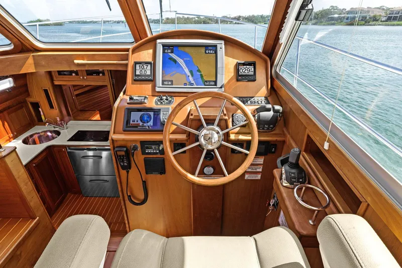 Five O'clock Yacht Photos Pics Interior of 2013 Sabre 38 Salon Express yacht with navigation equipment and wooden finish.