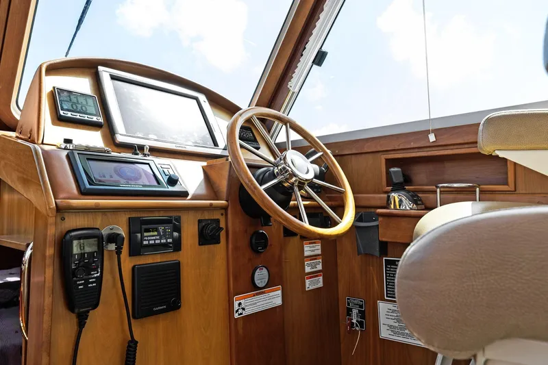 Five O'clock Yacht Photos Pics 2013 Sabre 38 Salon Express helm with wooden steering wheel and navigation equipment.