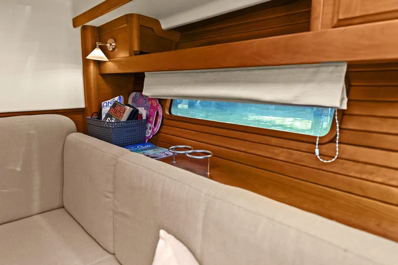 Five O'clock Yacht Photos Pics Interior of 2013 Sabre 38 Salon Express with wooden paneling and cozy seating area.