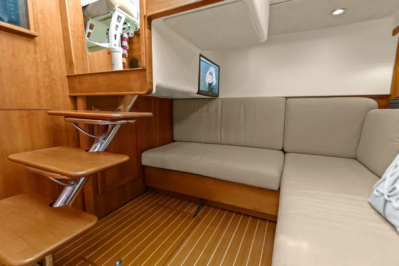 Five O'clock Yacht Photos Pics Interior of 2013 Sabre 38 Salon Express with cozy seating and wooden steps.