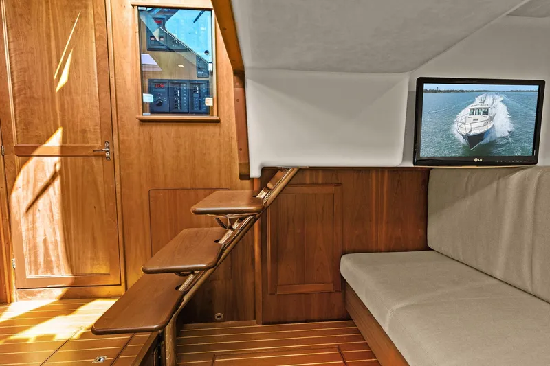 Five O'clock Yacht Photos Pics 2013 Sabre 38 Salon Express interior with wooden stairs, seating, and wall-mounted TV.