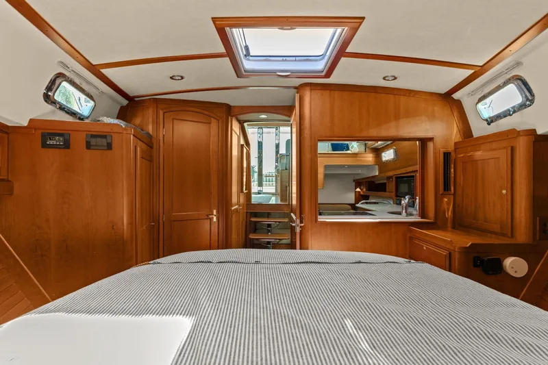 Five O'clock Yacht Photos Pics Interior of 2013 Sabre 38 Salon Express yacht, featuring wood paneling and a skylight.