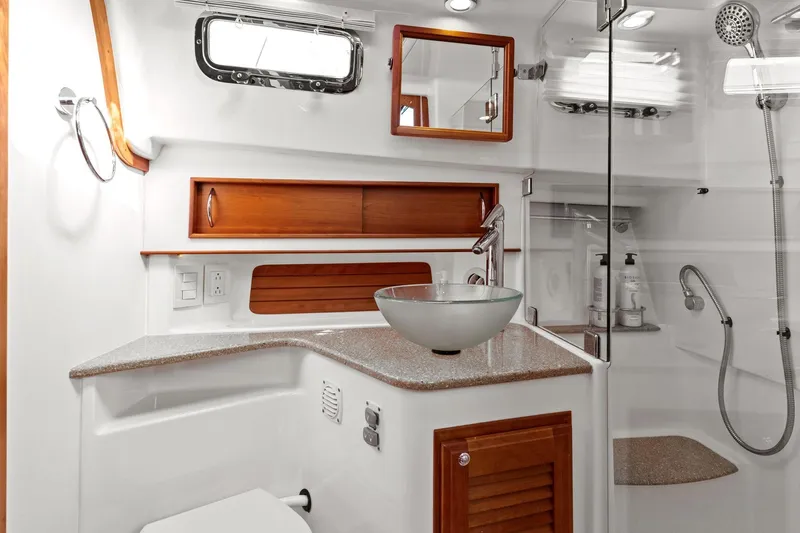 Five O'clock Yacht Photos Pics Luxurious bathroom in 2013 Sabre 38 Salon Express yacht with modern fixtures and wood accents.