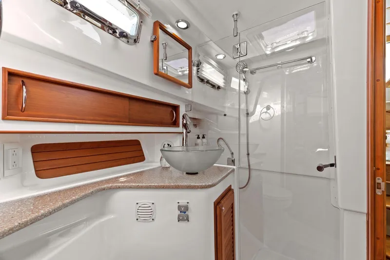 Five O'clock Yacht Photos Pics Luxurious bathroom in 2013 Sabre 38 Salon Express yacht with modern fixtures and wood accents.