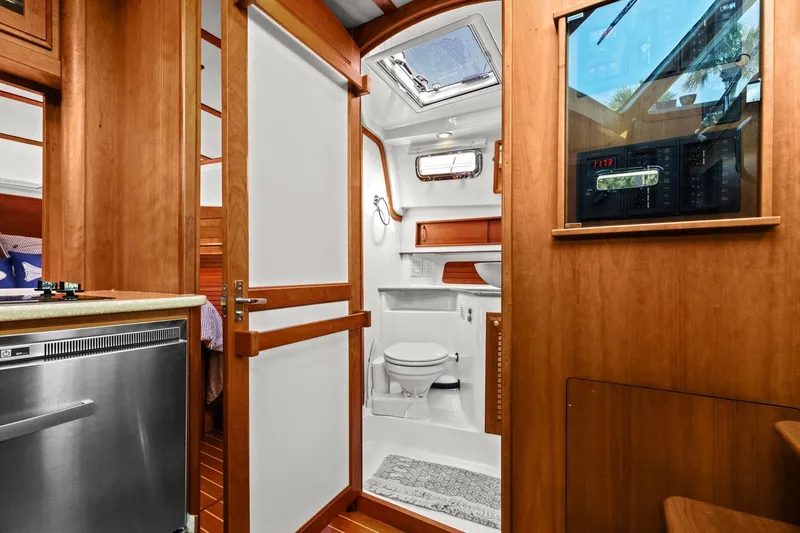 Five O'clock Yacht Photos Pics 2013 Sabre 38 Salon Express interior with wooden cabinetry and modern bathroom.