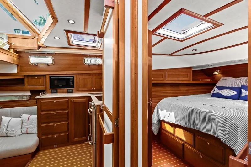 Five O'clock Yacht Photos Pics Interior of 2013 Sabre 38 Salon Express yacht, featuring cozy bedroom and kitchen area.