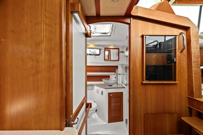 Five O'clock Yacht Photos Pics Interior of 2013 Sabre 38 Salon Express yacht, featuring a modern bathroom with wooden accents.