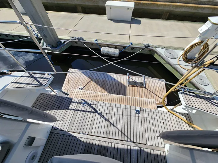 Just A Sign Yacht Photos Pics Beneteau Oceanis 40.1 yacht deck, 2022 model, docked at marina with wooden flooring.