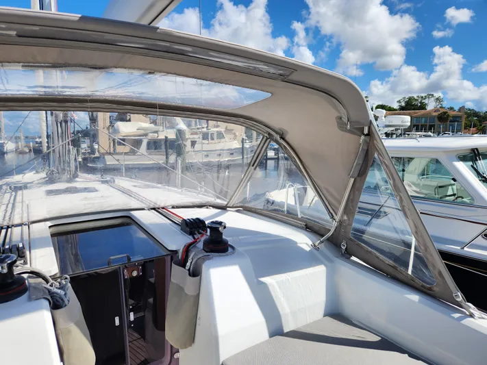 Just A Sign Yacht Photos Pics 2022 Beneteau Oceanis 40.1 sailboat cockpit with clear canopy, docked at marina.