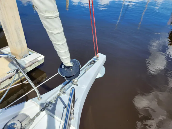 Just A Sign Yacht Photos Pics Beneteau Oceanis 40.1 sailboat bow, 2022 model, docked on calm water.