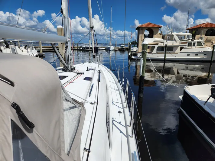Just A Sign Yacht Photos Pics 2022 Beneteau Oceanis 40.1 sailboat docked at a marina under a clear blue sky.