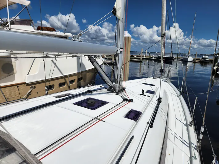 Just A Sign Yacht Photos Pics 2022 Beneteau Oceanis 40.1 sailboat docked at marina under clear blue sky.