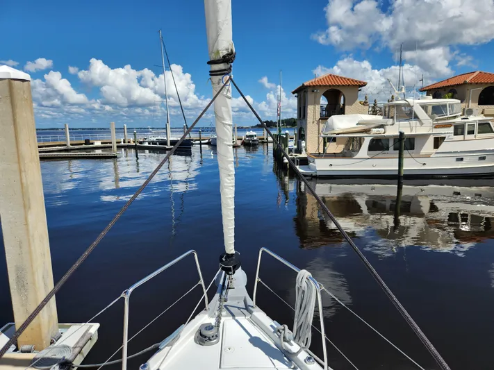 Just A Sign Yacht Photos Pics Bow view of 2022 Beneteau Oceanis 40.1 docked at a marina under a clear blue sky.