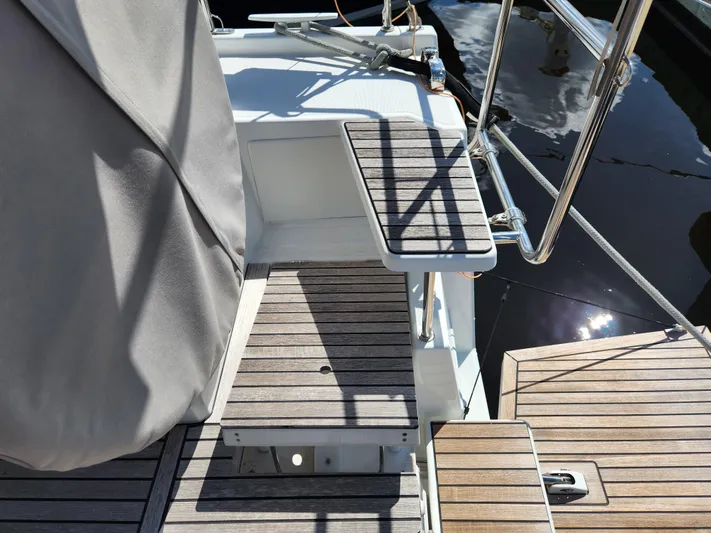 Just A Sign Yacht Photos Pics Beneteau Oceanis 40.1 yacht deck, 2022 model, featuring wooden steps and stainless steel railings.