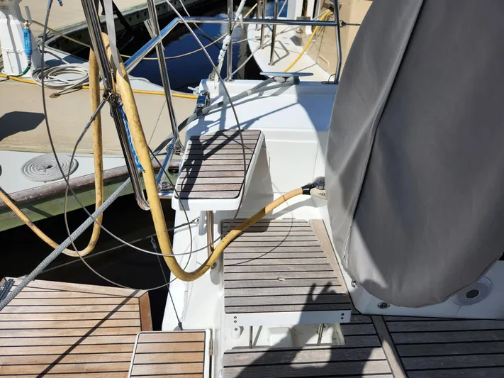 Just A Sign Yacht Photos Pics Beneteau Oceanis 40.1 yacht deck, 2022 model, featuring wooden steps and covered equipment.