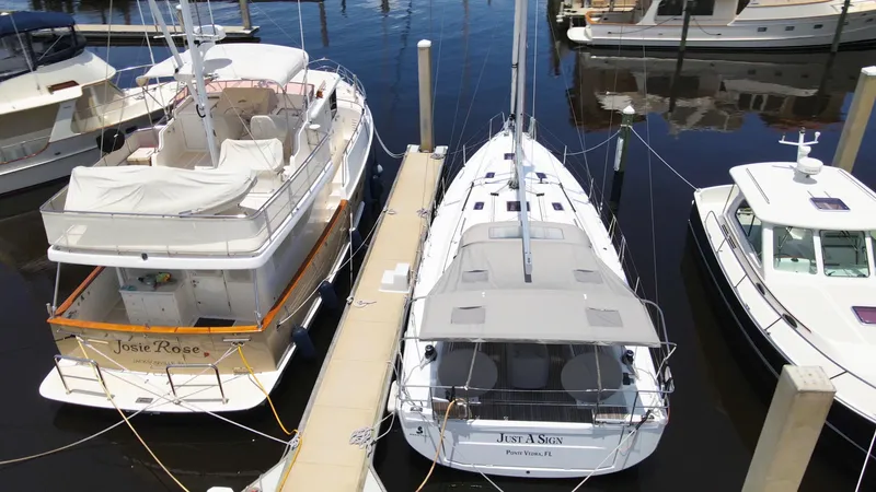 Just A Sign Yacht Photos Pics Beneteau Oceanis 40.1 yacht docked alongside other boats, 2022 model.