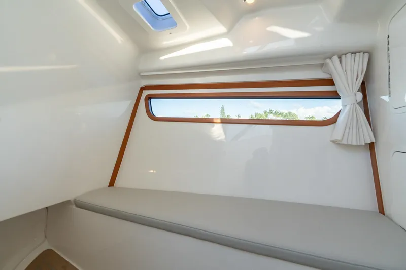 In-stock 2026 Mjm 3-053 Yacht Photos Pics Interior cabin of 2026 MJM 3 boat with window and seating.